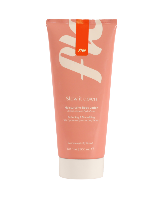 Pink tube of body lotion with white text on a white background