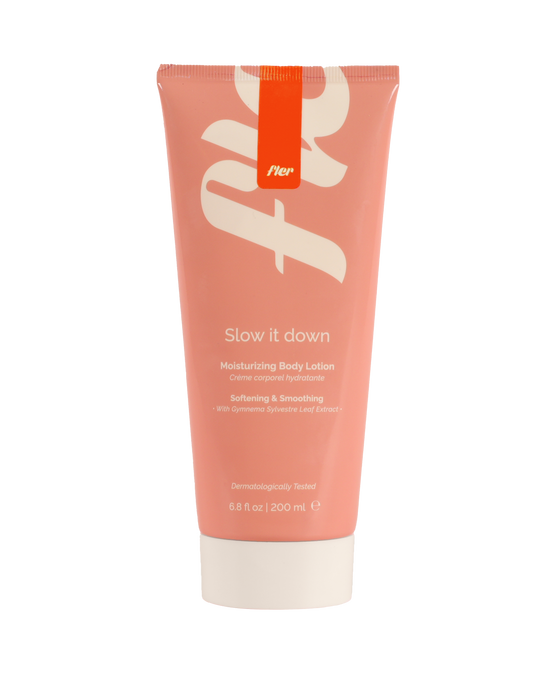 Pink tube of body lotion with white text on a white background