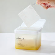 Hand pulling a toner pad from a container labeled 'mixsoon' on a white background