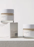 Two jars of 'mixsoon' cream and its packaging on a light gray background